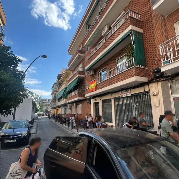 Familias aguardando el reparto semanal de alimentos de la Asociación Solidaridad Esperanza en la calle Hernán Cortés, Getafe (Madrid)